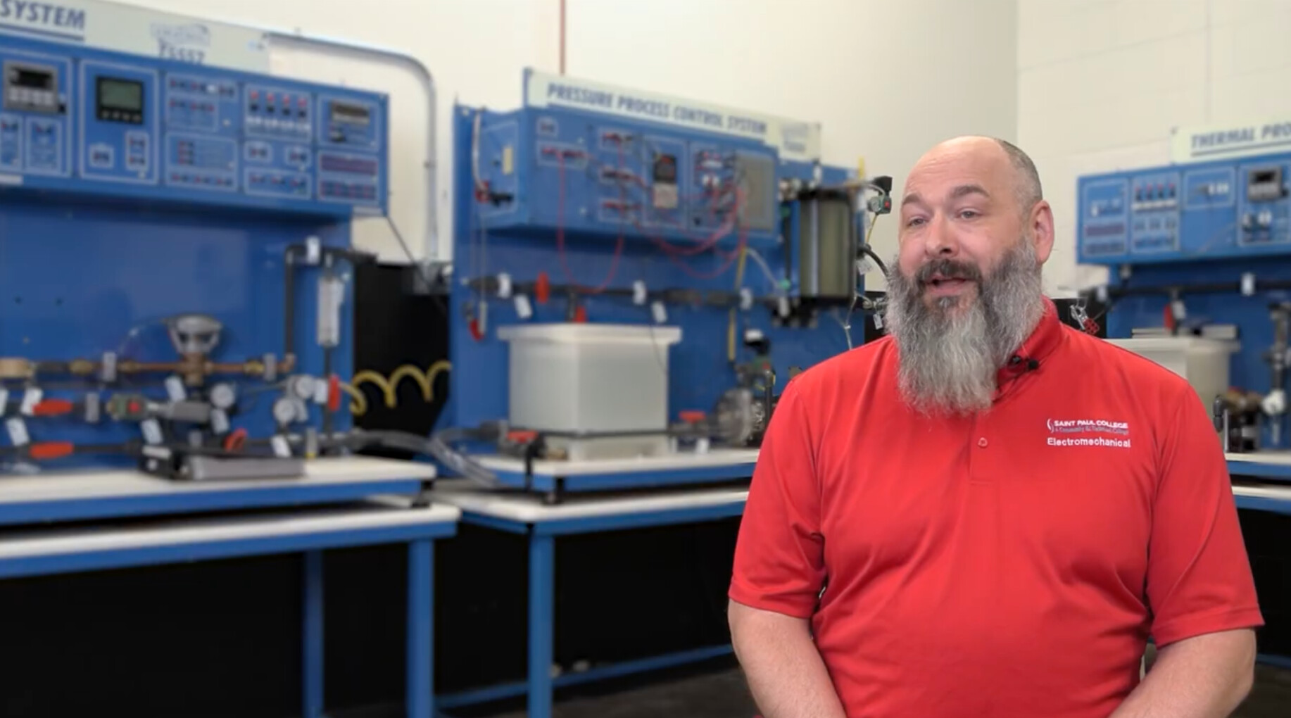 Travis Schachtner in front of electromechanical equipment